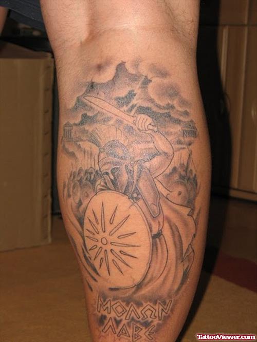 Grey Ink Greek Tattoo On Back Leg