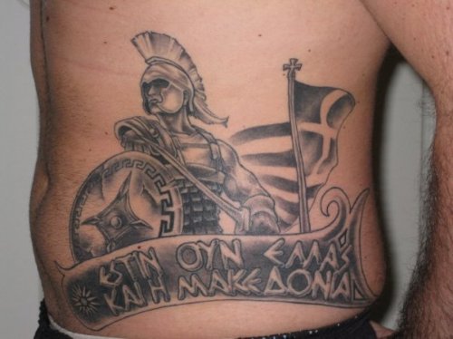 Grey Ink Greek Tattoo On Man Rib Side