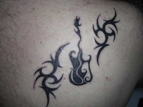 Black Tribal and Guitar Tattoo On Back