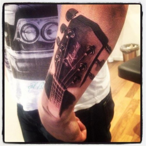 Grey Ink Guitar Tattoo On Left Arm