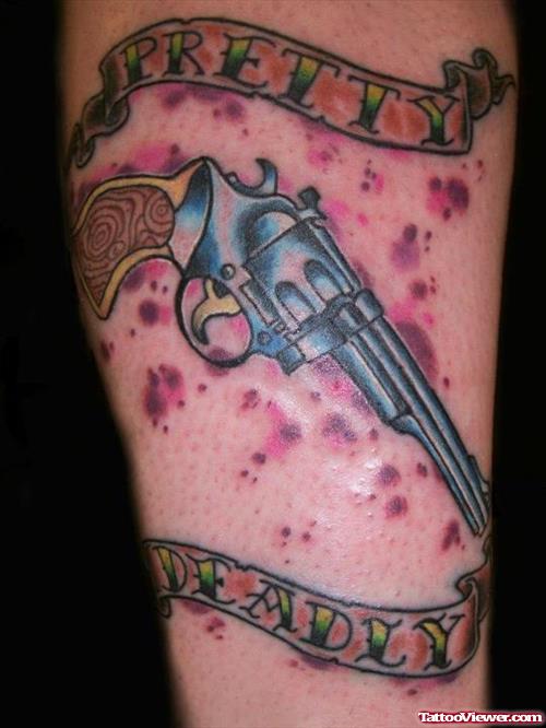 Colored Gun With Banner Tattoo On Arm