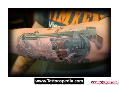 Colored Gun Tattoo On Man Left Sleeve