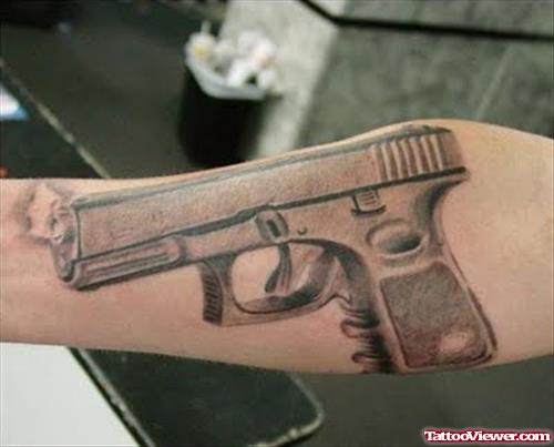 Awesome Grey Ink Gun Tattoo On Arm