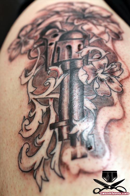 Grey Ink Flowers And Gun Tattoo On Shoulder