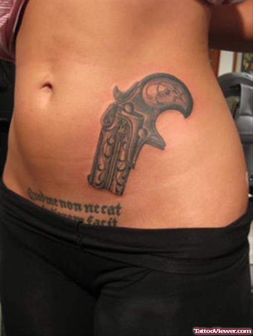 Grey Ink Gun Tattoo On Left Hip