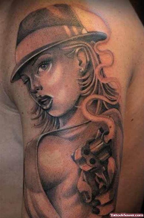 Grey Ink Pinup Girl With Gun Tattoo On Left Half Sleeve