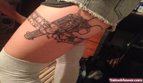Awesome Garter And Lace Gun Tattoo On Left Thigh