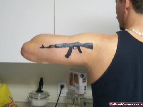 Gun Tattoo On Man Left Half Sleeve
