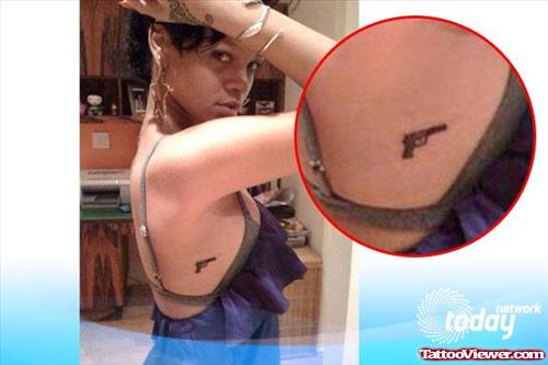 Attractive Rihanna Gun Tattoo On Side Rib