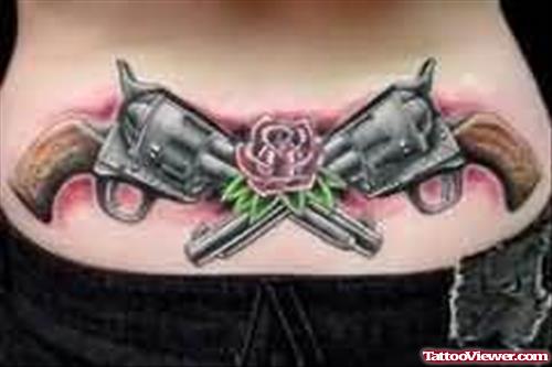 Guns And Flower Tattoo On Lower Back