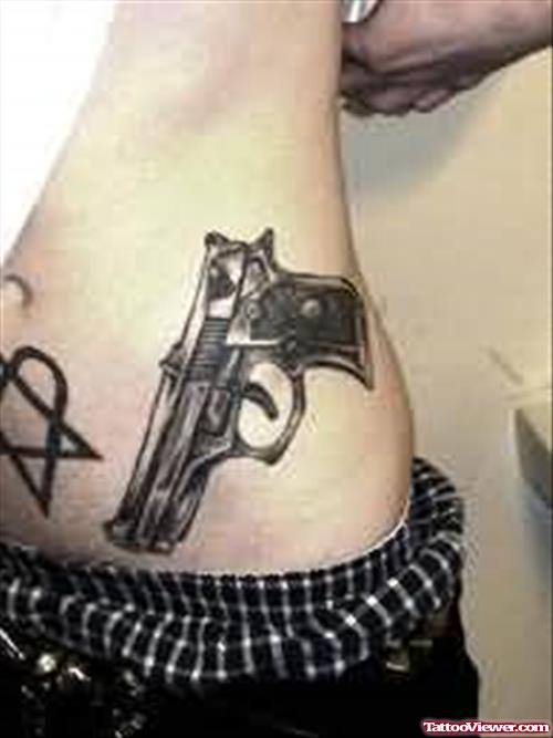 Gun And Star Tattoo On Rib