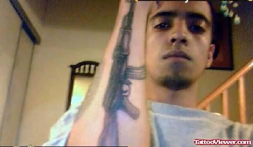 Big Gun Tattoo On Elbow