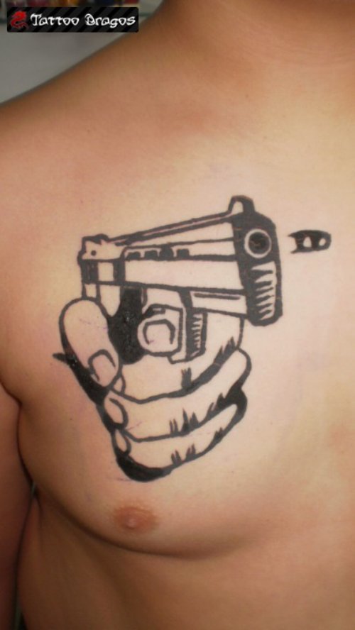 Shooting Gun In Hand Tattoo On Man Chest
