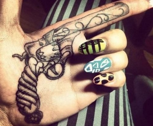 Grey Ink Gun Tattoo On Girl Left Hand
