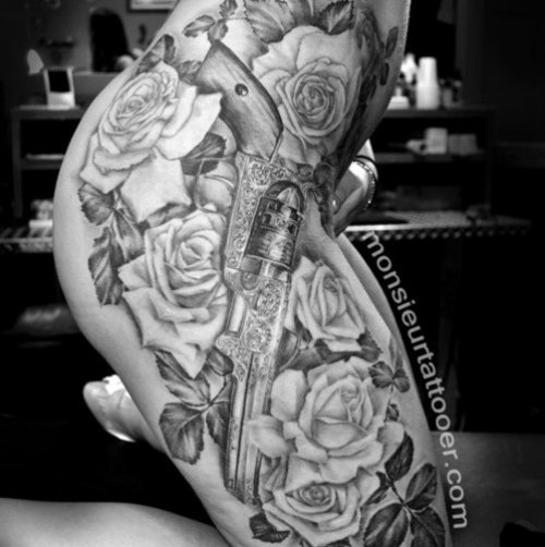 Grey Ink Rose Flowers And Gun Tattoo On Side