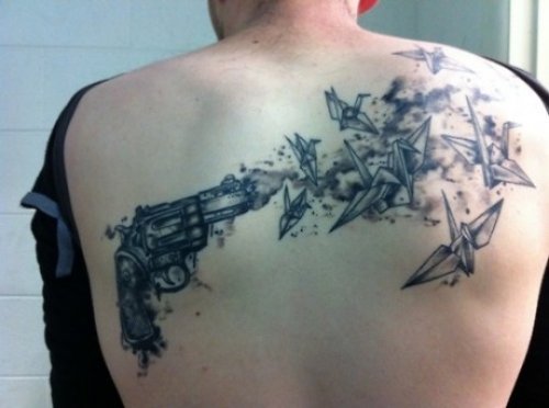 Flying Birds Shooting With Gun Tattoo On Back