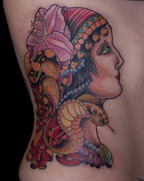 Colored Snake And Gypsy Head Tattoo On Side Rib