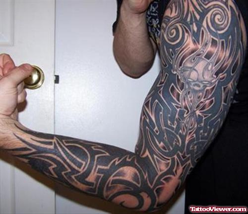 Amazing Black Ink Tribal Left Half Sleeve Tattoo