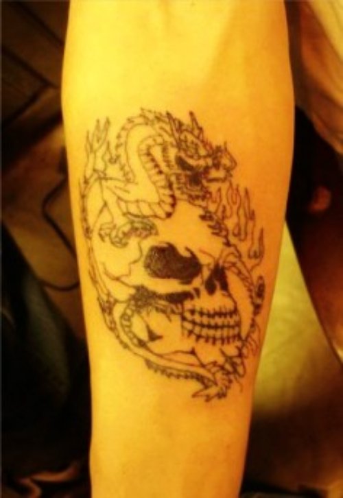 Grey Ink Skull Halloween Tattoo On Arm