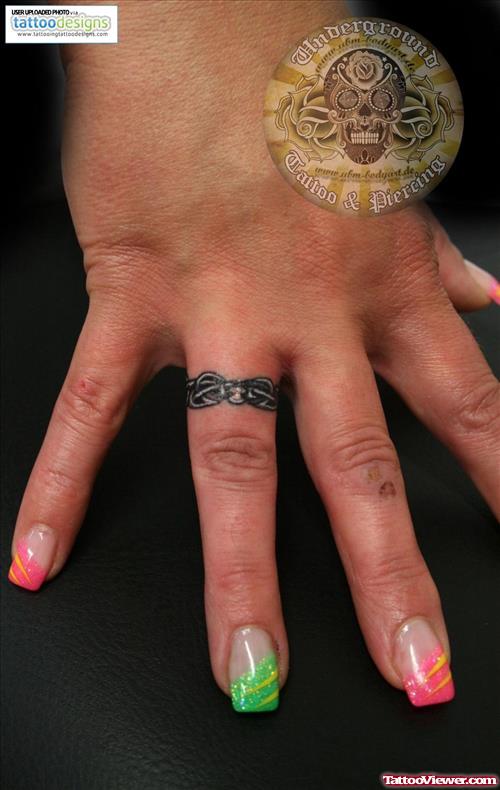 Grey Ink Celtic Ring Tattoo On Finger