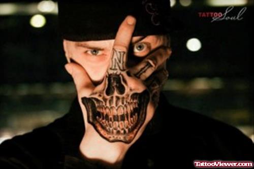 Amazing Grey Ink Skull Hand Tattoo