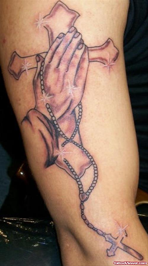 Grey Ink Cross And Praying Hands With Rosary Tattoo On Sleeve