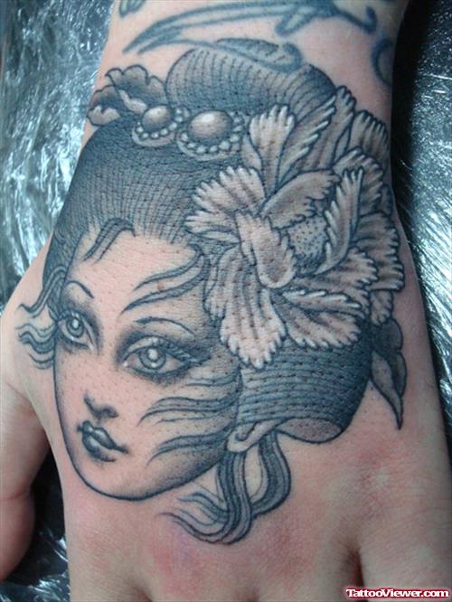 Grey Ink Girl Head Tattoo On Left Hand