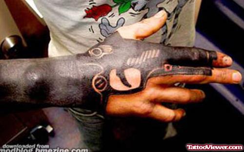 Black Ink Large Gun Tattoo On Right Hand