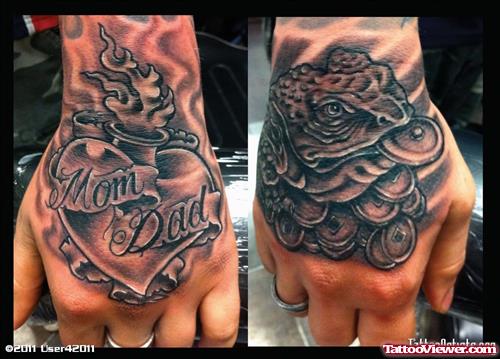 Grey Ink Foo Dog And Mom Dad Banner With Burning Heart Hand Tattoo
