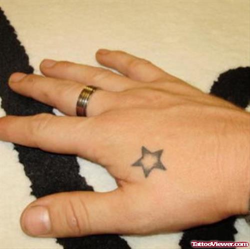 Grey Ink Star Hand Tattoo