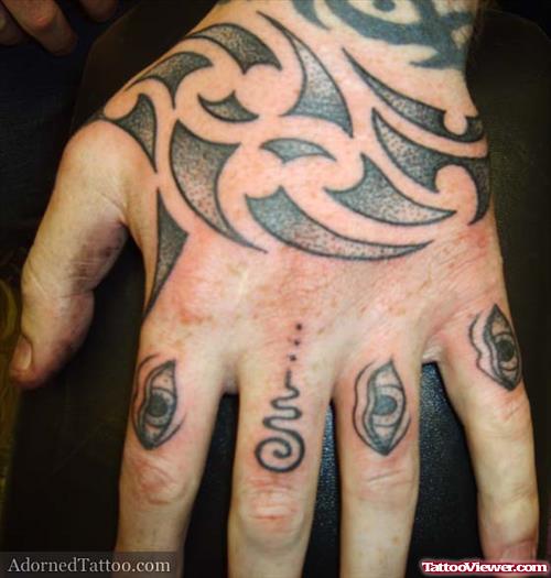 Grey Ink Maori Tribal Tattoo On Left Hand