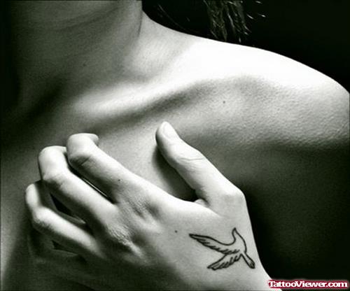 Amazing Black Ink Flying Bird Hand Tattoo