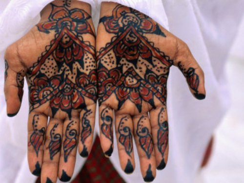 Girl Showing Colored Henna Hand Tattoo