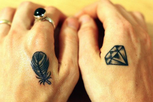 Grey Ink Diamond And Feather Hand Tattoos