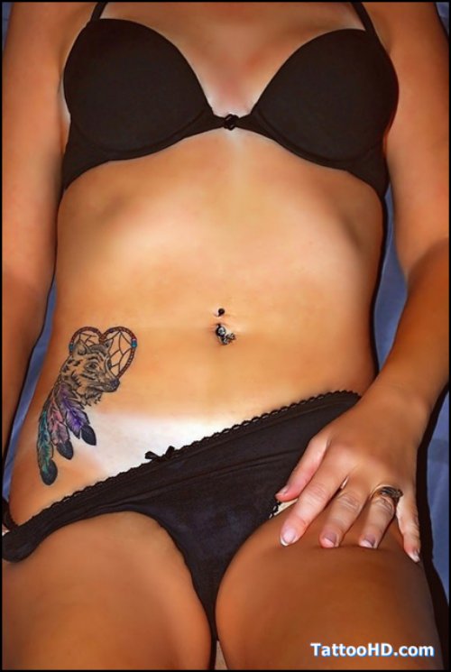 Girl Showing Her Harley Tattoo On Right Hip
