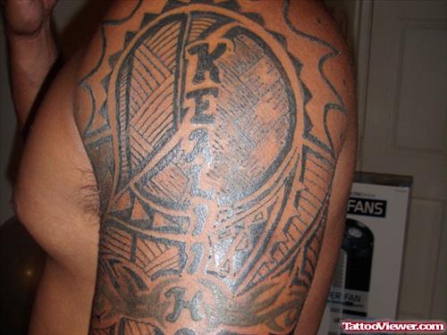 Grey Ink Hawaiian Tattoo On Man Left Half Sleeve