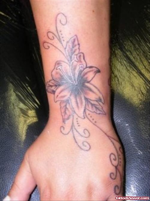 Grey Ink Hawaiian Flower Tattoo On Left Wrist