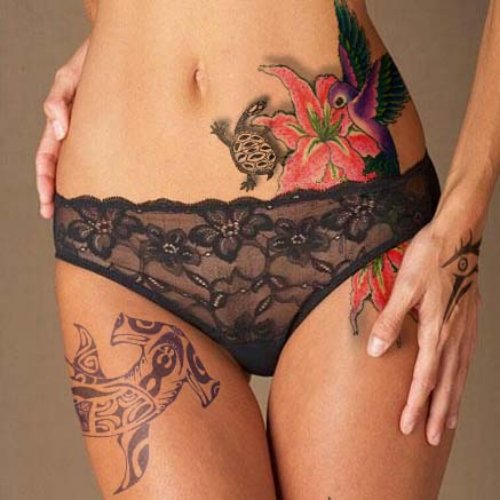 Girl With Hawaiian Tattoo On Side And Thigh