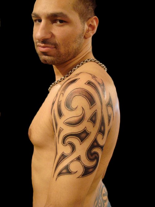 Grey Ink Tribal Hawaiian Tattoo On Man Left Half Sleeve