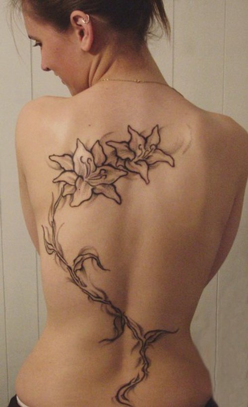 Girl Showing Her Hawaiian Tattoo On Back