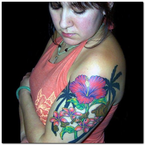 Lady Showing Her Hawaiian Tattoo On Left Half SLeeve
