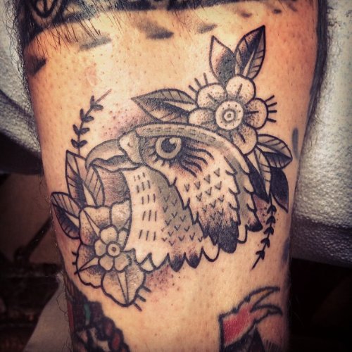 Grey Ink Flowers And Hawk Head Tattoo On Bicep