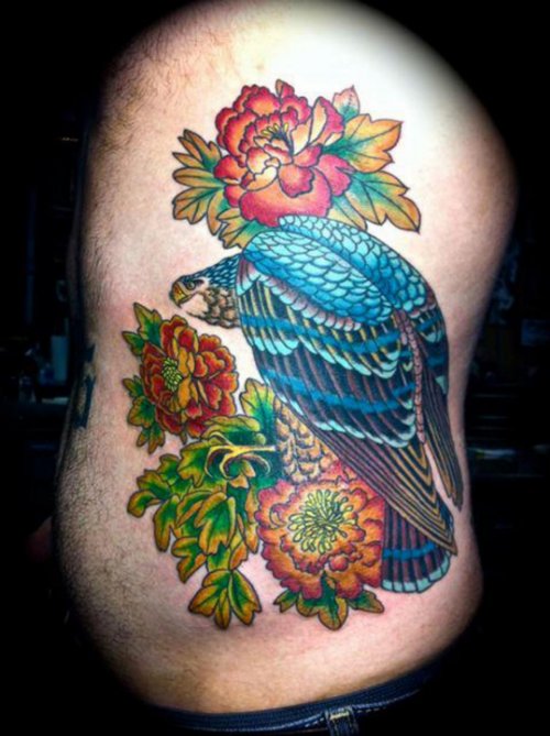 Colored Flowers And Hawk Tattoo On Side Rib