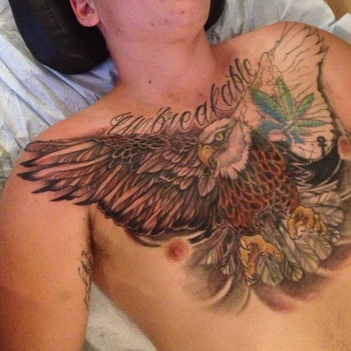 Unbreakable Word And Colored Flying Hawk Tattoo On Chest