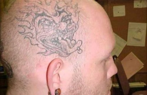 Grey Ink Joker Head Tattoo