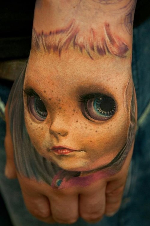 Grey Ink 3D Doll Head Tattoo On Left Hand