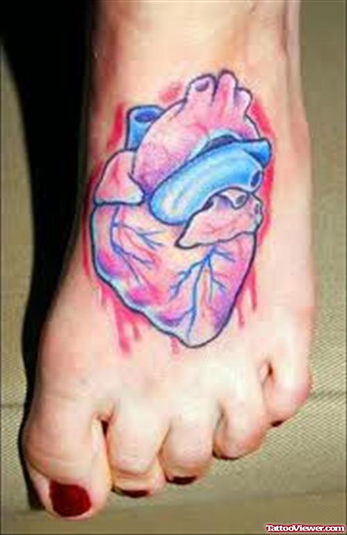 Colored Human Heart Tattoo On Left Foot