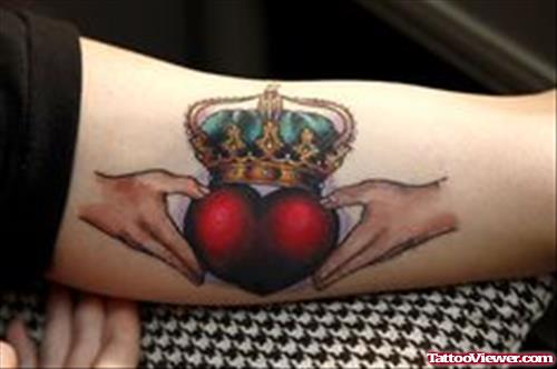 Colored Claddagh Heart Tattoo On Bicep