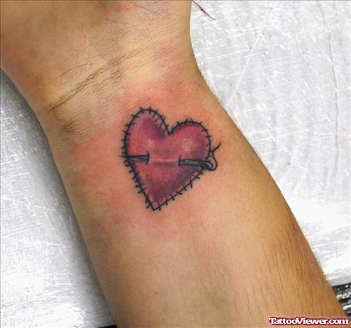 Pierced Heart Tattoo On Right Wrist