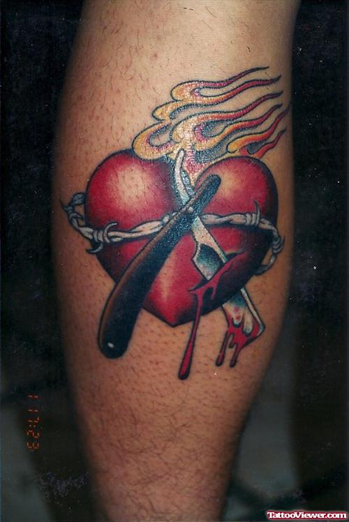 Razor And Heart Tattoo On Back Leg